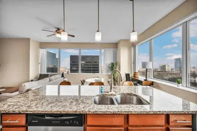 a kitchen with a sink and a large window at Sky High Suite Downtown w/ Parking Available $ in Cleveland