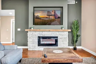 a living room with a fireplace and a couch at Sky High Suite Downtown w/ Parking Available $ in Cleveland