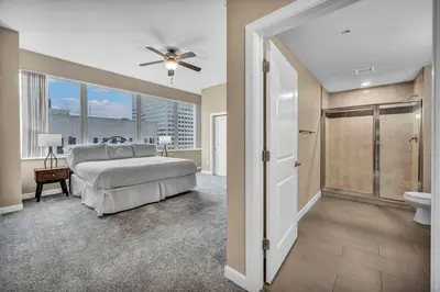 a large bedroom with a bed and a bathroom at Sky High Suite Downtown w/ Parking Available $ in Cleveland