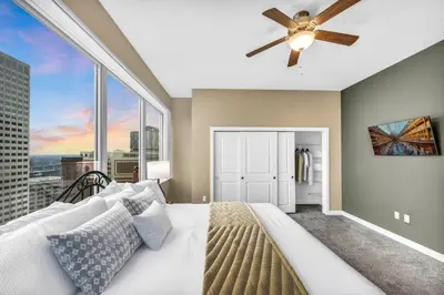 a bedroom with a large bed and a ceiling fan at Sky High Suite Downtown w/ Parking Available $ in Cleveland