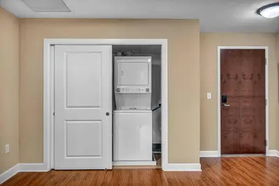 an empty room with a door and a refrigerator at Sky High Suite Downtown w/ Parking Available $ in Cleveland