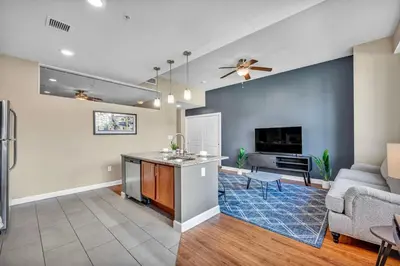 a living room with a couch and a table at Modern Condo w/ Cathedral Views in Great Location in Cleveland