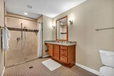 a bathroom with a shower and a sink and a toilet at Modern Condo w/ Cathedral Views in Great Location in Cleveland