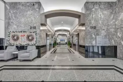 a lobby of a building with chairs and tables at Modern Condo w/ Cathedral Views in Great Location in Cleveland