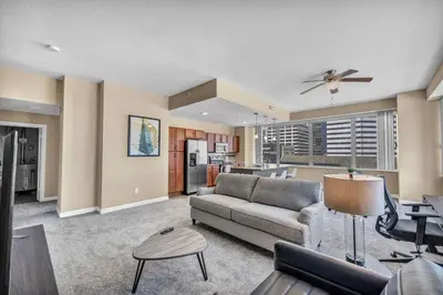 a living room with a couch and a kitchen at Luxury Condo w/ Lake Views! Center of Downtown in Cleveland