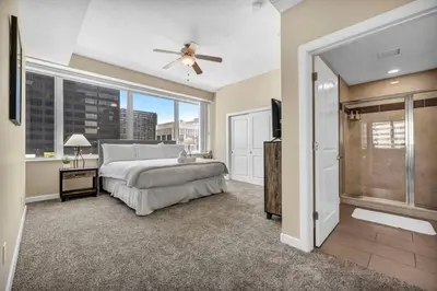 a bedroom with a bed and a large window at Luxury Condo w/ Lake Views! Center of Downtown in Cleveland