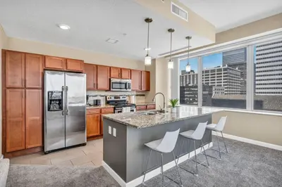 a kitchen with stainless steel appliances and a large window at Luxury Condo w/ Lake Views! Center of Downtown in Cleveland