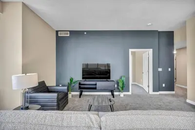 a living room with a couch and a tv at Luxury Condo w/ Lake Views! Center of Downtown in Cleveland