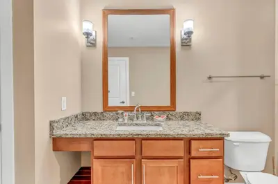 a bathroom with a sink and a mirror at Luxury High-Rise Condo in Amazing Location | Gym in Cleveland