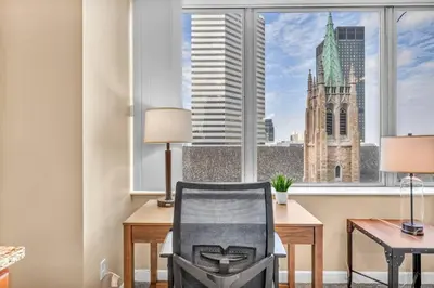 an office with a desk and a chair in front of a window at Luxury High-Rise Condo in Amazing Location | Gym in Cleveland