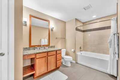 a bathroom with a sink and a tub and a toilet at Luxury High-Rise Condo in Amazing Location | Gym in Cleveland