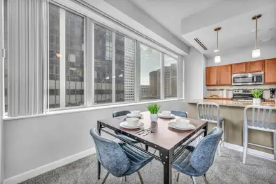 a kitchen and dining room with a table and chairs at Luxury High-rise Condo w/ Views! Heart of Downtown in Cleveland