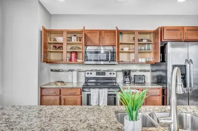 a kitchen with wooden cabinets and stainless steel appliances at Luxury High-rise Condo w/ Views! Heart of Downtown in Cleveland