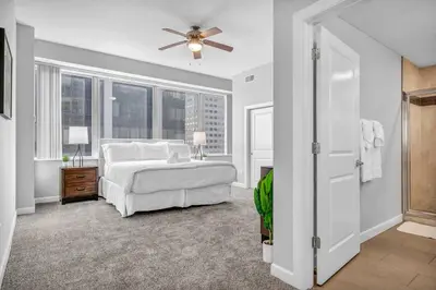 a bedroom with a bed and a ceiling fan at Luxury High-rise Condo w/ Views! Heart of Downtown in Cleveland
