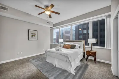 a bedroom with a bed and a ceiling fan at 10th Floor Downtown High-Rise | Gym in Cleveland