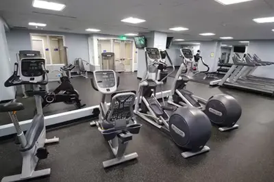 a gym with several treadmills and cardio machines at Cityview Escape • Stylish 1BR+Gym & Parking $ in Cleveland