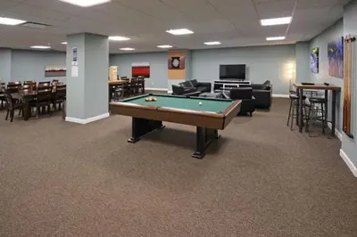 a pool table in a room with tables and chairs at Cityview Escape • Stylish 1BR+Gym & Parking $ in Cleveland