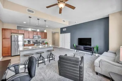a large living room with a couch and a kitchen at Cityview Escape • Stylish 1BR+Gym & Parking $ in Cleveland