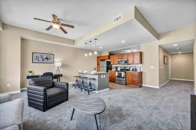 a living room and kitchen with a couch and a table at Cityview Escape • Stylish 1BR+Gym & Parking $ in Cleveland