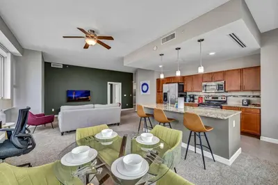 a living room with a dining room and a kitchen at Stunning 11th Floor Corner Unit w/Amazing DT Views in Cleveland