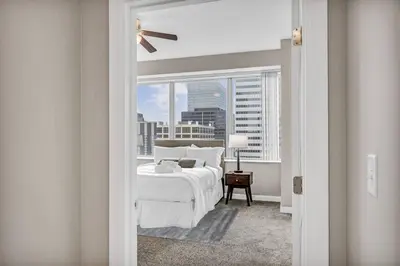 a bedroom with a bed and a window with a view at Stunning 11th Floor Corner Unit w/Amazing DT Views in Cleveland