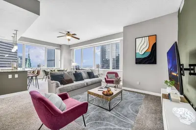 a living room with a couch and a table at Stunning 11th Floor Corner Unit w/Amazing DT Views in Cleveland