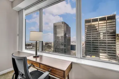a desk in a room with a window at Stunning 11th Floor Corner Unit w/Amazing DT Views in Cleveland