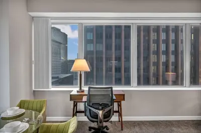 a room with a desk and chairs and a large window at SkyTower 2BD | Parking Available | Downtown in Cleveland