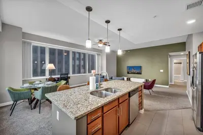 a kitchen and living room with a sink and a counter at SkyTower 2BD | Parking Available | Downtown in Cleveland