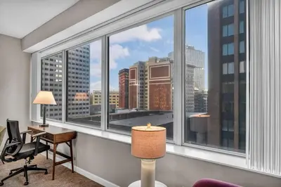 a room with a large window with a view of a city at SkyTower 2BD | Parking Available | Downtown in Cleveland