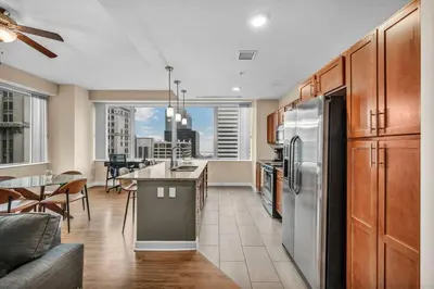 a kitchen with a refrigerator and a table in it at Luxury High-Rise w/ City View | Paid Parking | Gym in Cleveland
