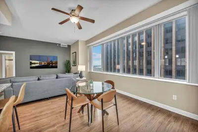 a living room with a couch and a glass table at Luxury High-Rise w/ City View | Paid Parking | Gym in Cleveland