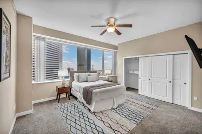a bedroom with a bed and a ceiling fan at Luxury High-Rise w/ City View | Paid Parking | Gym in Cleveland