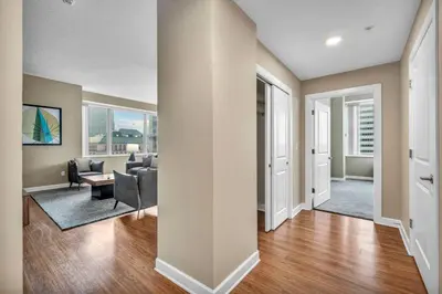 a living room with a couch and a table at Luxury High-Rise w/ City View | Paid Parking | Gym in Cleveland
