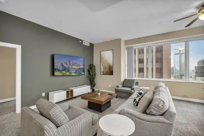 a living room with two couches and a table at Luxury 13th Floor Condo: Downtown/ Parking $ /Gym in Cleveland