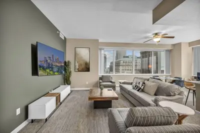 a living room with a couch and a table at Luxury 13th Floor Condo: Downtown/ Parking $ /Gym in Cleveland
