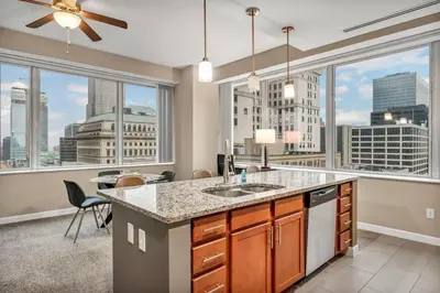 a kitchen with a large window with a view of the city at Luxury 13th Floor Condo: Downtown/ Parking $ /Gym in Cleveland