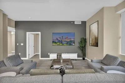 a living room with two couches and a piano at Luxury 13th Floor Condo: Downtown/ Parking $ /Gym in Cleveland