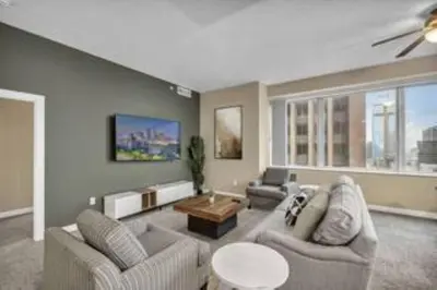 a living room with two couches and a table at 13th Floor SkyTower: Paid Parking | Downtown | Gym in Cleveland