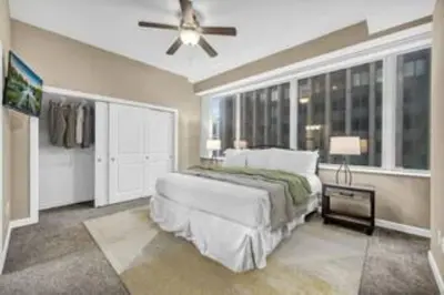 a bedroom with a bed and a ceiling fan at 13th Floor SkyTower: Paid Parking | Downtown | Gym in Cleveland