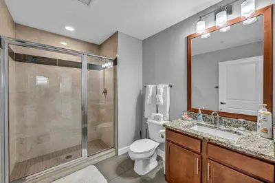 a bathroom with a shower and a toilet and a sink at 14th Floor Lux Downtown Condo w/ LAKE VIEWS & Gym in Cleveland