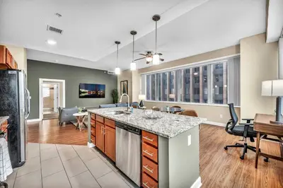 an open kitchen and living room with a dining room at 16th Floor Downtown High-Rise | Paid Parking & Gym in Cleveland