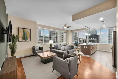 a living room with a couch and a table at 16th Floor Downtown High-Rise | Paid Parking & Gym in Cleveland