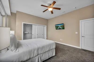 a bedroom with a bed and a ceiling fan at 16th Floor Downtown High-Rise | Paid Parking & Gym in Cleveland
