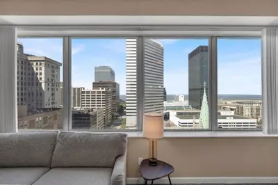 a living room with a couch and a large window at Luxury High-Rise • 18th Floor Condo • Parking $ in Cleveland