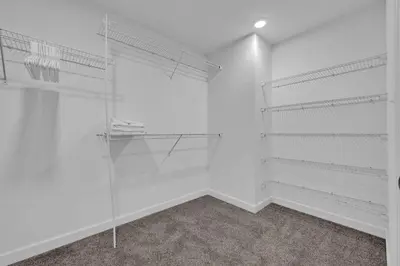 a walk in closet with white walls and shelves at Luxury High-Rise • 18th Floor Condo • Parking $ in Cleveland
