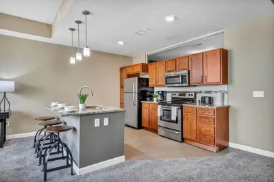 a kitchen with wooden cabinets and a counter top at Luxury High-Rise • 18th Floor Condo • Parking $ in Cleveland