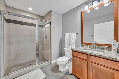 a bathroom with a shower and a toilet and a sink at Luxury 21st Floor Penthouse | Great Downtown VIEWS in Cleveland