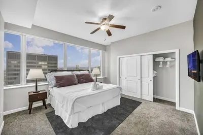 a bedroom with a bed and a ceiling fan at Luxury 21st Floor Penthouse | Great Downtown VIEWS in Cleveland