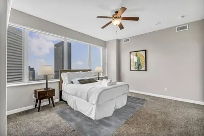 a bedroom with a bed and a ceiling fan at Luxury 21st Floor Penthouse | Great Downtown VIEWS in Cleveland